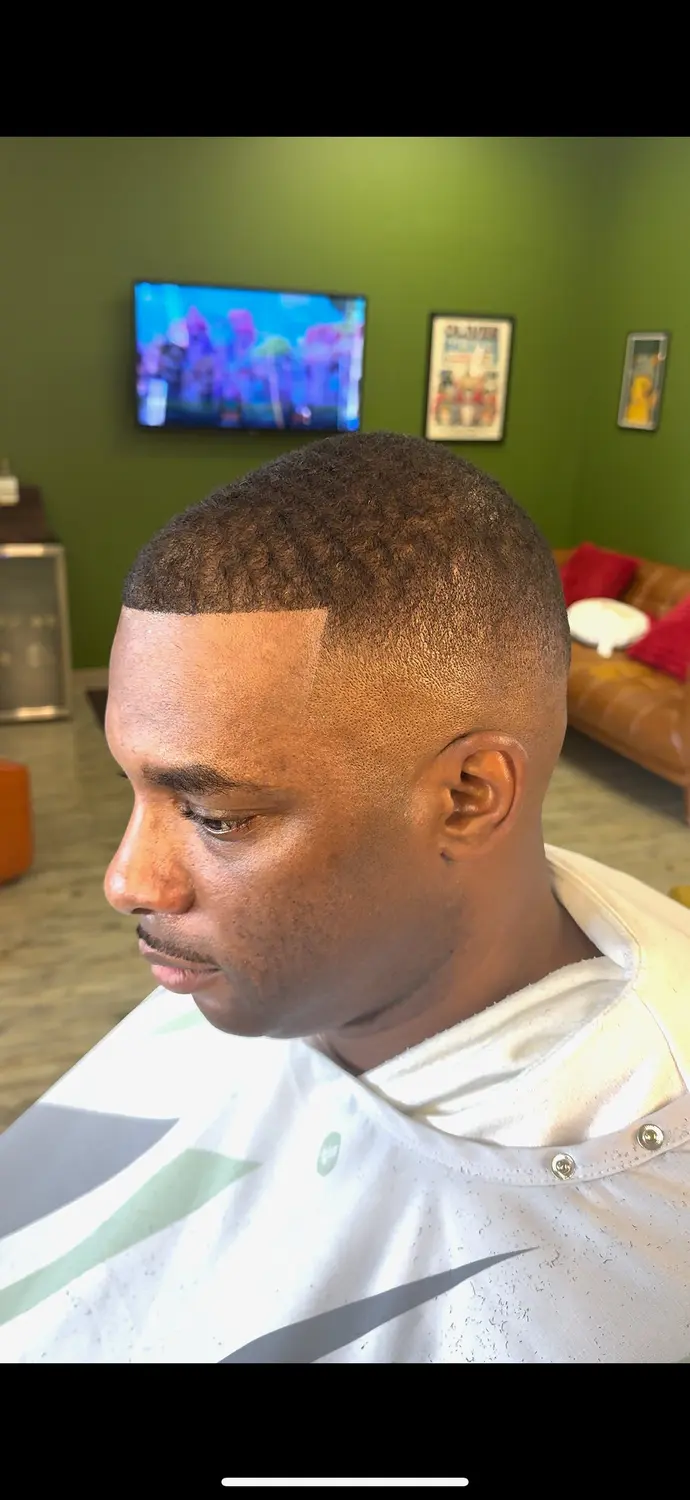 Buzz cut with sharp line up at One For All Barbershop