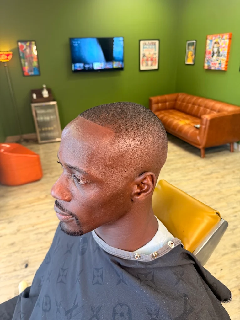 Mid fade with line up at One For All Barbershop
