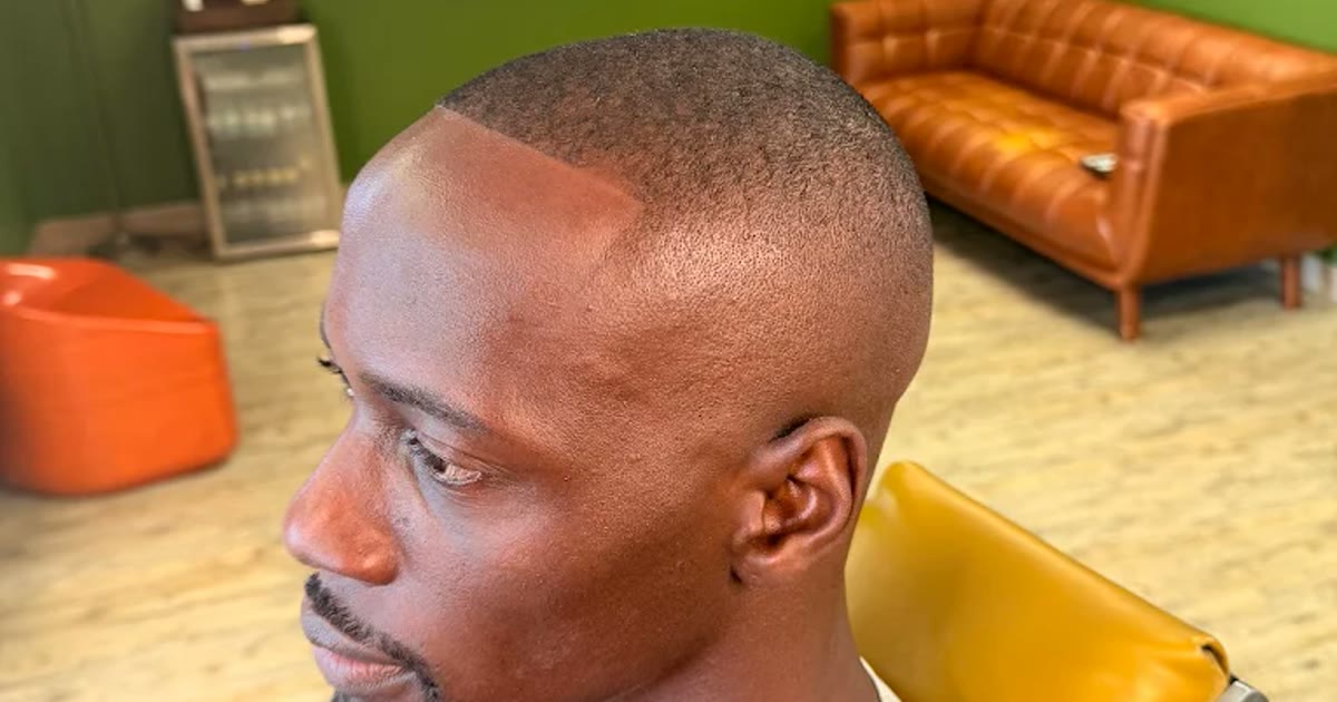 A clean fade blended from the skin up at One For All Barbershop