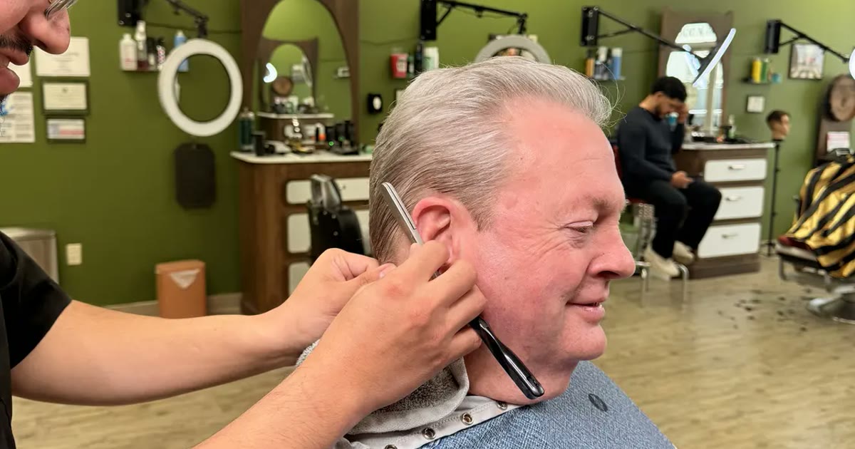 A hot-towel straight razor shave underway in the shave parlor